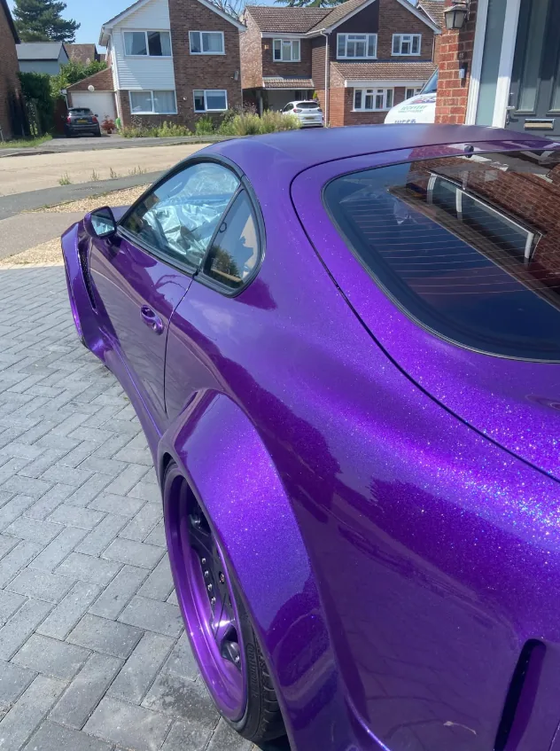 Glossy purple sports car after detailing